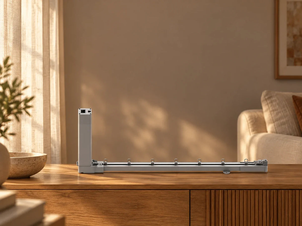 Illustrative 87E curtain motor and rail on a timber console in a warm living room.